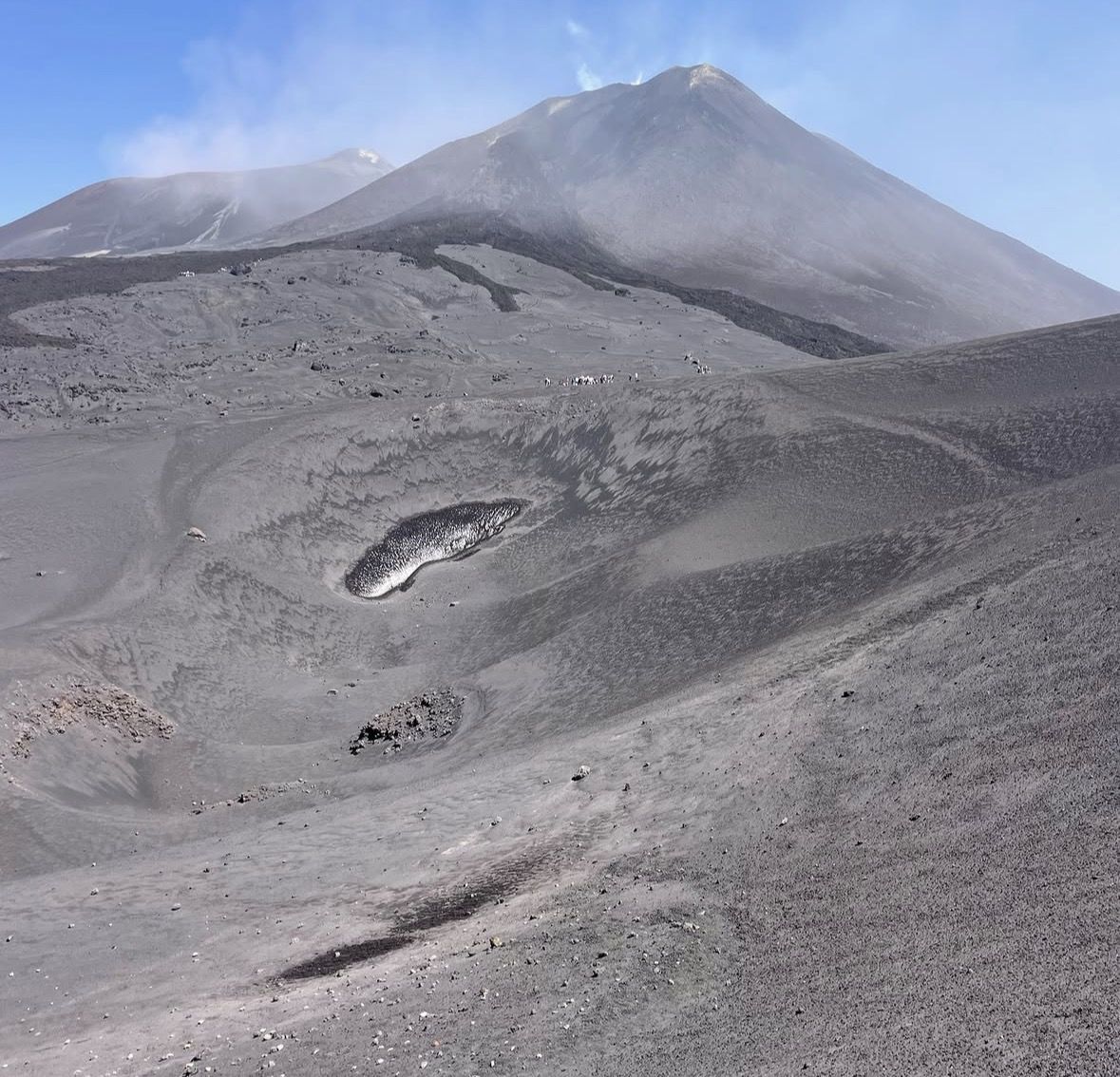 Mountain rescue team vehicle stationed at a volcanic park checkpoint with warning signs in the foreground